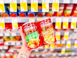 hand holding campbells chunky soup in walgreens