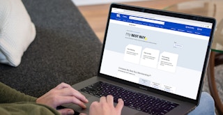 a person looking at the best buy website on their macbook computer