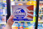 hand holding a box of klondike bars
