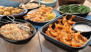 A table of Red Lobster menu items including shrimp skewers, Walt's favorite shrimp, shrimp alfredo pasta, Cheddar Bay biscuits, rice, ...