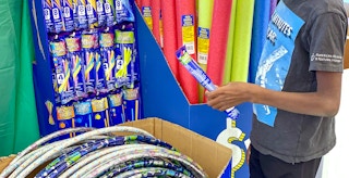 child looking at glow sticks and summer toys in dollar tree