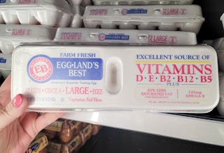 hand holding a carton of eggland's best eggs at kroger