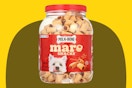 Stock image of 40 oz Milk Bone Maro Snacks for small dogs over yellow/olive max shape background