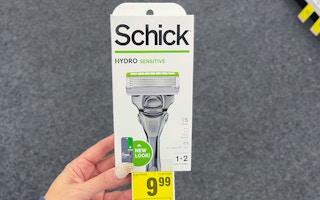 hand holding a schick razor with a cvs sale tag