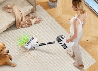 a person vacuuming a rug