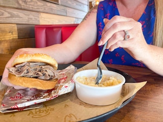 a person eating arbys