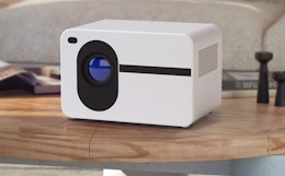 a bluetooth projector on a wooden table 