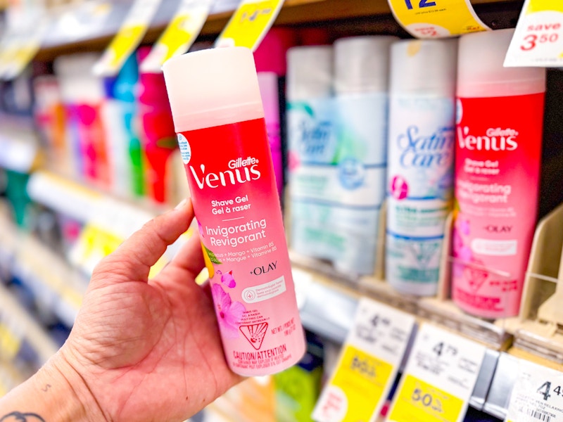 person holding a gillette venus shave gel by the display shelf