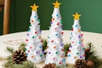 Brightown Lighted Ceramic Christmas Tree Set of 3 on a dining room table.