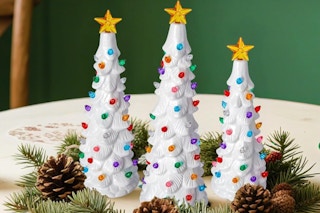 Brightown Lighted Ceramic Christmas Tree Set of 3 on a dining room table.