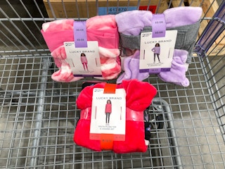 3 kids clothing sets in a cart