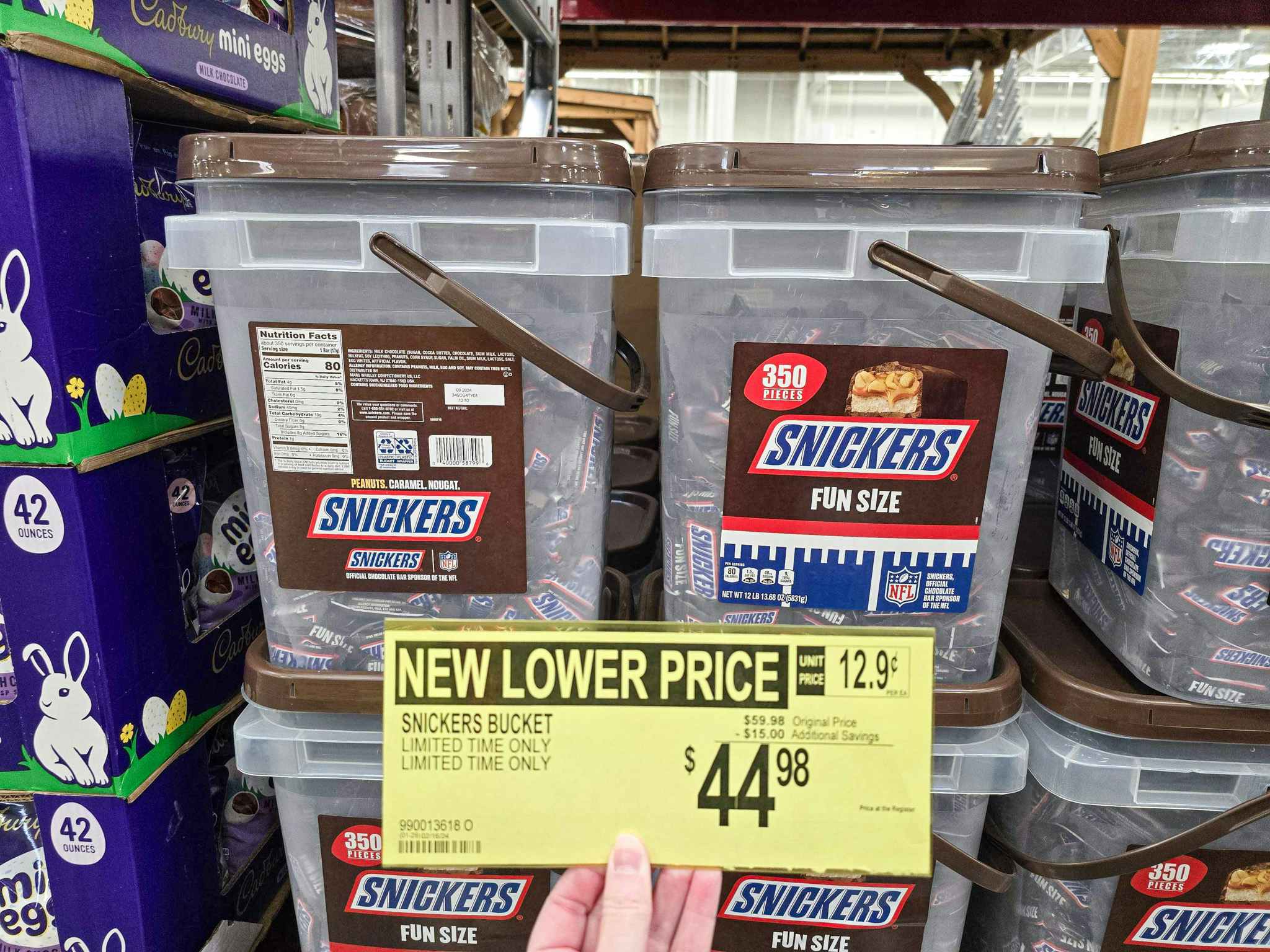 buckets of snickers with a person holding a sign for $44.98