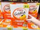 a large box of goldfish crackers being grabbed in store