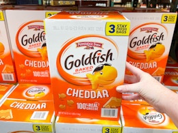 a large box of goldfish crackers being grabbed in store