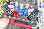 person pushing a cart with axe body wash, neutrogena acne patches, crest mouthwash, and lubriderm lotion