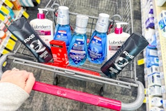 person pushing a cart with axe body wash, neutrogena acne patches, crest mouthwash, and lubriderm lotion