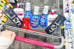 person pushing a cart with axe body wash, neutrogena acne patches, crest mouthwash, and lubriderm lotion