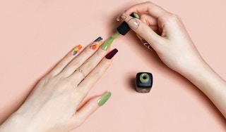a person painting their long nails