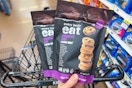 hand holding two bags of every body eat gluten free cookies