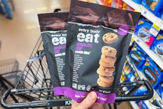 hand holding two bags of every body eat gluten free cookies