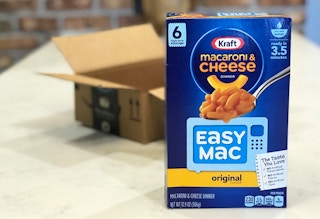 A box of Kraft Easy Mac in front of an open Amazon box.