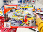 hand holding matchbox playset in target aisle