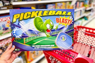 hand holding a pickleball blast game in front of a target card