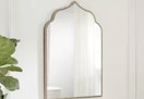 gold arched accent mirror