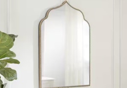 gold arched accent mirror