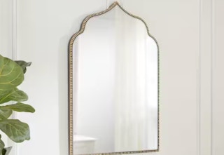 gold arched accent mirror