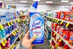 person holding lysol toilet bowl cleaner in an aisle