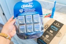 holding oral-b floss in bathroom