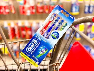 a 4-pack of oral-b toothbrushes in a cart