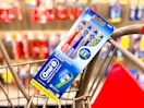 a 4-pack of oral-b toothbrushes in a cart