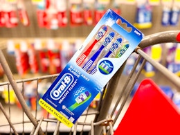 a 4-pack of oral-b toothbrushes in a cart