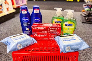 neutrogena makeup wipes, colgate toothpaste, softsoap hand soap, and nivea body lotion on a red basket