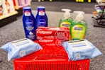 neutrogena makeup wipes, colgate toothpaste, softsoap hand soap, and nivea body lotion on a red basket