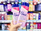 hand holding two bottles of Nair body cream