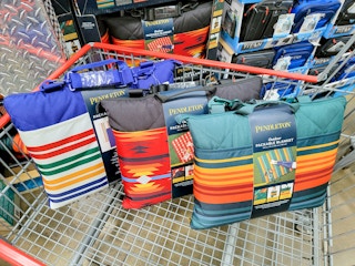 3 packable outdoor blankets in a cart