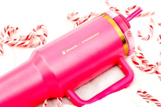 the new pink stanley on a blanket next to candy canes