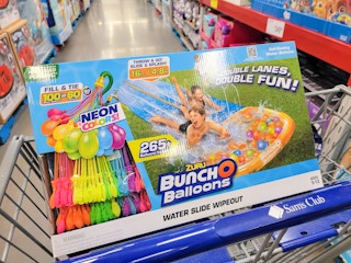 a double lane waterslide with 265 balloons in a cart