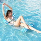 a person laying in a pool on a pool hammock