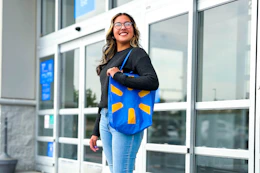 person walking out of Walmart with a Walmart reusable tote