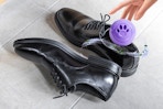 person putting shoe deodorizer in shoe