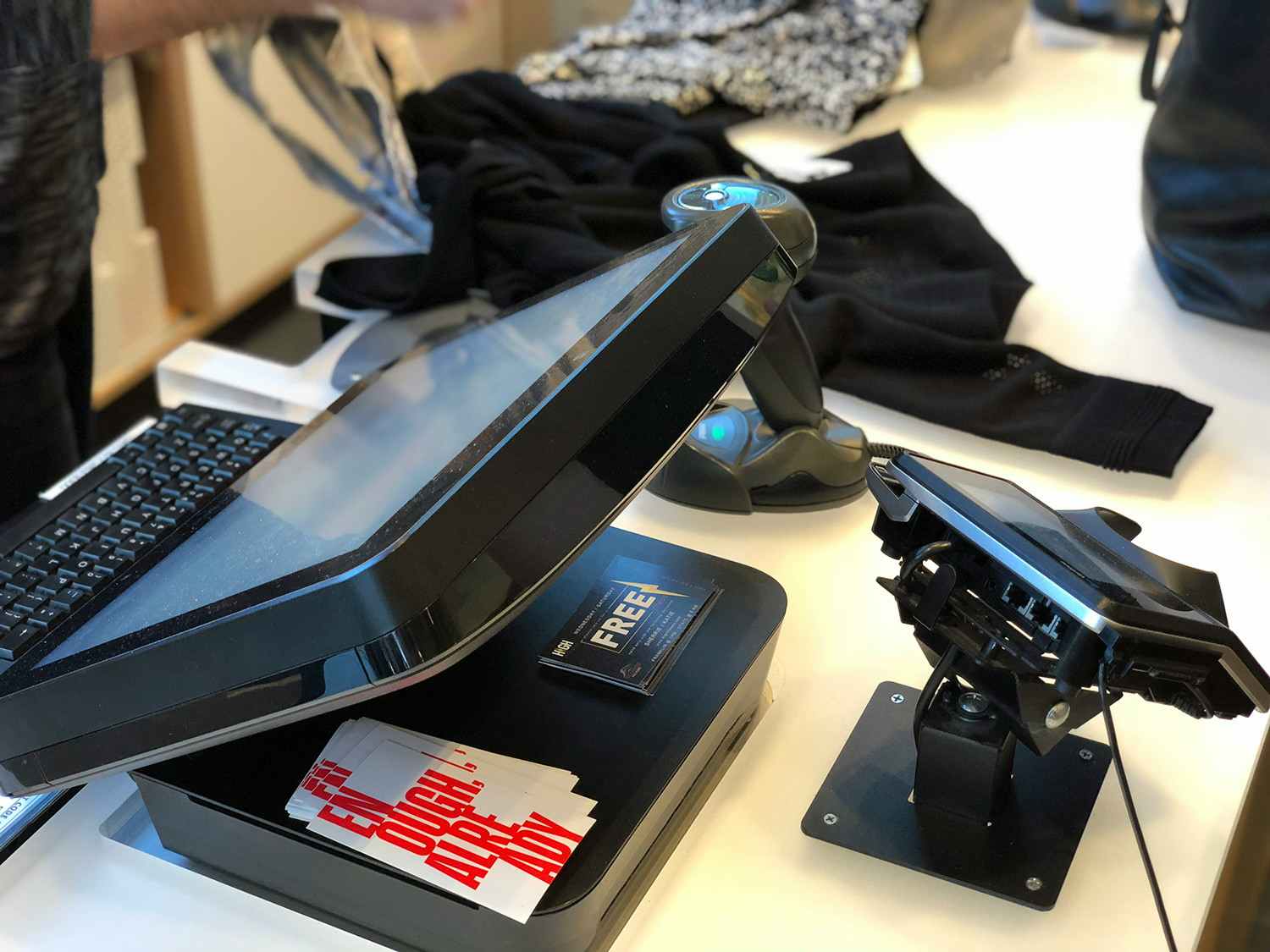 A Lululemon employee ringing up items at the checkout counter in a Lululemon store.