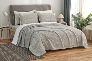 Lifestyle image of JML black/white knitted bedding set on bed in bedroom