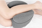 person using knee pillow