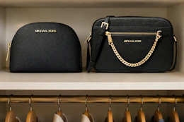 2 Michael Kors bags in closet shelf