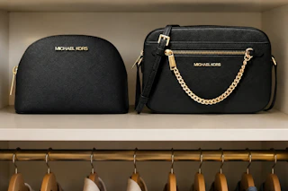 2 Michael Kors bags in closet shelf