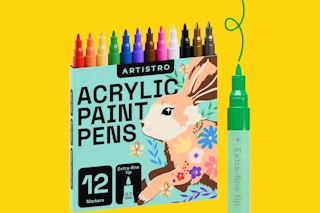 A package of 12 acrylic paint pens on a yellow background. One green pen makes a curlique.